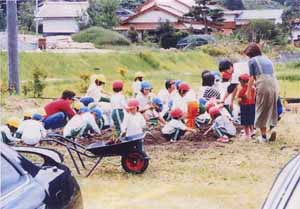 保育園児による花壇の花植えの写真