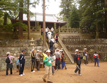 地区にある寺社や施設をみんなで歩いている写真